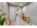 Hallway features tile flooring, neutral paint, and tasteful decor leading to other areas at 600 Buchannan Dr, Davenport, FL 33837