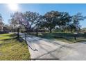 View of the property's gated entrance, a long driveway, and a mailbox with address at 6917 Roman Ct, Clermont, FL 34714