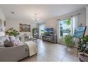 Bright living room with tile flooring, neutral paint, large windows, and stylish decor at 8067 Crushed Pepper Ave, Orlando, FL 32817