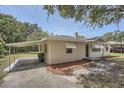 A single-story home with a covered parking area and well-maintained yard at 811 S Lone Oak Dr, Leesburg, FL 34748