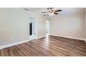 Bright living room featuring wood-look floors, neutral walls, and natural light at 811 S Lone Oak Dr, Leesburg, FL 34748