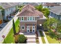 Charming home with lush landscaping, portico, arched car port, and clay tile roof in a well-manicured neighborhood at 8268 Bellow St, Orlando, FL 32827