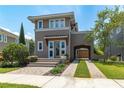Charming two-story home featuring a lovely portico, arched car port, clay tile roof and beautiful landscaping at 8268 Bellow St, Orlando, FL 32827