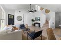 Bright living room featuring white walls, a ceiling fan, modern furnishings, and light wood flooring at 9987 Triple Crown Cir, Orlando, FL 32825