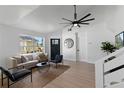 Inviting living room with comfortable seating, large windows, and modern decor accents at 9987 Triple Crown Cir, Orlando, FL 32825