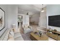 Open-concept living room with neutral paint, plush furniture, and view to the dining area at 1012 Marisol Ct, Orlando, FL 32828