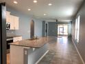Open-concept kitchen with granite counters, stainless appliances, and a spacious island at 10126 Beach Port Dr, Winter Garden, FL 34787