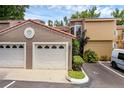 Attached two-car garage with tile roof, landscaping and parking spaces at this home at 1013 Inlet Way, Altamonte Springs, FL 32714