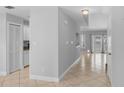 Entry hallway leads to a living space with bright white cabinets, tile floor and natural light at 1013 Inlet Way, Altamonte Springs, FL 32714