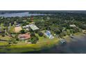 Panoramic aerial view of a lakeside home with mature trees offering serene living with a private dock at 11923 Lake Butler Blvd, Windermere, FL 34786