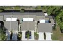 Aerial view of townhomes showcasing the rooftops, driveways and surrounding landscape of the neighborhood at 136 Teriwood Ct, Fern Park, FL 32730