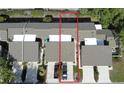 Aerial view of the townhome units, including rooftops, driveways, and lawn, highlighted by red outline at 136 Teriwood Ct, Fern Park, FL 32730