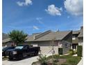 Inviting townhome with a well-kept yard, garage, and a charming American flag adding curb appeal at 136 Teriwood Ct, Fern Park, FL 32730