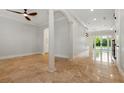 Spacious living room with polished floors, pillars, and sliding glass doors leading to the outdoor pool at 1361 Palmer Ave., Winter Park, FL 32789
