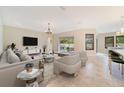 Spacious living room featuring tile floors, comfortable seating, and sliding doors to the patio at 14516 Sunbridge Cir, Winter Garden, FL 34787