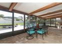 Enclosed patio with comfortable seating and views of the pool and backyard, ideal for outdoor dining at 1529 Ensenada Dr, Orlando, FL 32825