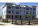Exterior view of new townhomes being constructed with protective wrap and block foundation at 15447 Hamlin Park Drive, Winter Garden, FL 34787
