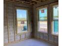 Interior view of new construction featuring framed walls, windows, and concrete block at 15447 Hamlin Park Drive, Winter Garden, FL 34787
