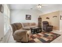 Comfortable living room featuring neutral colors, tile floors, ceiling fan and a decorative rug at 160 Chestnut Ave, Orange City, FL 32763