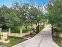 Gated driveway with mature trees and landscaping, enhancing the curb appeal of this lovely property at 19123 Sheldon St, Orlando, FL 32833