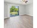 Open living room with sliding glass doors leading to balcony with green views and natural light at 1932 Lake Atriums Cir # 69, Orlando, FL 32839