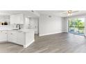 Bright open floor plan with modern kitchen, island, stainless steel appliances, and sliding glass door to balcony at 1932 Lake Atriums Cir # 69, Orlando, FL 32839