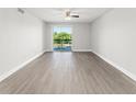 Spacious living room with sliding glass doors leading to a balcony, offering natural light at 1932 Lake Atriums Cir # 69, Orlando, FL 32839