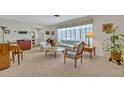Bright living room with plush carpeting, large windows, and comfortable seating at 2040 Mohawk Trl, Maitland, FL 32751