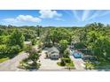 Aerial view showcases the property's landscaped yard, and proximity to lush greenery at 205 S Highland Ave, Apopka, FL 32703