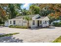 Well-maintained exterior with mature landscaping, ample parking, and side garage at 205 S Highland Ave, Apopka, FL 32703