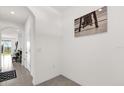 Bright hallway featuring tile flooring, white walls, and stylish decor at 2224 Tay Wes Dr, St Cloud, FL 34771