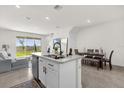 Open kitchen featuring an island, stainless steel appliances, and seamless flow into dining area at 2224 Tay Wes Dr, St Cloud, FL 34771