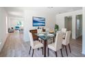 Formal dining room with stylish glass table and views into the adjacent living room at 2260 Suanee Ave, Eustis, FL 32726