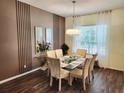 Elegant dining room with wood floors and a modern chandelier at 236 Boxwood Dr, Davenport, FL 33837