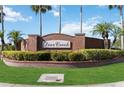 Welcoming Deer Creek community sign with lush greenery and brick detailing at 2481 Deer Creek Blvd, St Cloud, FL 34772