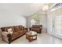 Bright living room with tile floors, vaulted ceiling, and plenty of natural light at 2481 Deer Creek Blvd, St Cloud, FL 34772