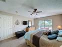 A sunlit bedroom featuring a king-size bed, TV and an outside view to the pool at 2641 Hemingway Ave, Haines City, FL 33844