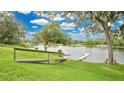 Scenic view of a serene lake from the backyard, featuring a dock and lush greenery at 2658 Adele Pl, Lake Mary, FL 32746
