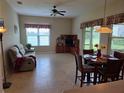 Cozy living area with tile flooring, a comfortable sofa, and a dining table with seating for four at 2710 Gorst Rd, Winter Garden, FL 34787