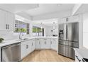 Modern kitchen featuring stainless steel appliances, sleek white cabinetry, and ample counter space for cooking at 2903 Clear Way, Orlando, FL 32805