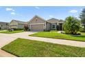 Attractive single-story home with landscaped front yard and neutral color palette at 2941 Marlberry Ln, Clermont, FL 34714