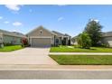 Well maintained single-story home showcasing an attached garage and a neat front lawn at 2941 Marlberry Ln, Clermont, FL 34714