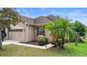 Beautiful single-story home showcasing lush landscaping, including palm trees and a well-maintained lawn at 30245 Cheval St, Mount Dora, FL 32757