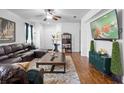 Comfortable living room features a plush sectional sofa, a large TV, wood floors, and stylish decor at 30245 Cheval St, Mount Dora, FL 32757