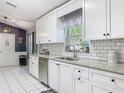 Bright kitchen with white cabinets, granite countertops, subway tile backsplash, stainless steel appliances, and tile flooring at 3104 Lime Tree Dr, Edgewater, FL 32141
