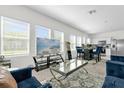 Open-concept living area with modern furnishings, large windows, and a view of the kitchen at 3206 Water Sprite St, Orlando, FL 32808