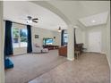 A spacious living room featuring neutral walls, large windows and tile floors at 3259 Alling Ct, Deltona, FL 32725