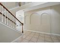 Spacious foyer featuring arched wall decor and tile flooring, leading to the living spaces at 4208 Lugano Ct, Kissimmee, FL 34746