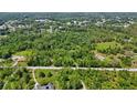 Picturesque aerial view captures a home and land with a road nearby, surrounded by lush green trees at 4825 N Fort Christmas Rd, Christmas, FL 32709