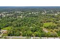 Expansive aerial view shows the lush landscape surrounding a property with a home nestled among the trees at 4825 N Fort Christmas Rd, Christmas, FL 32709